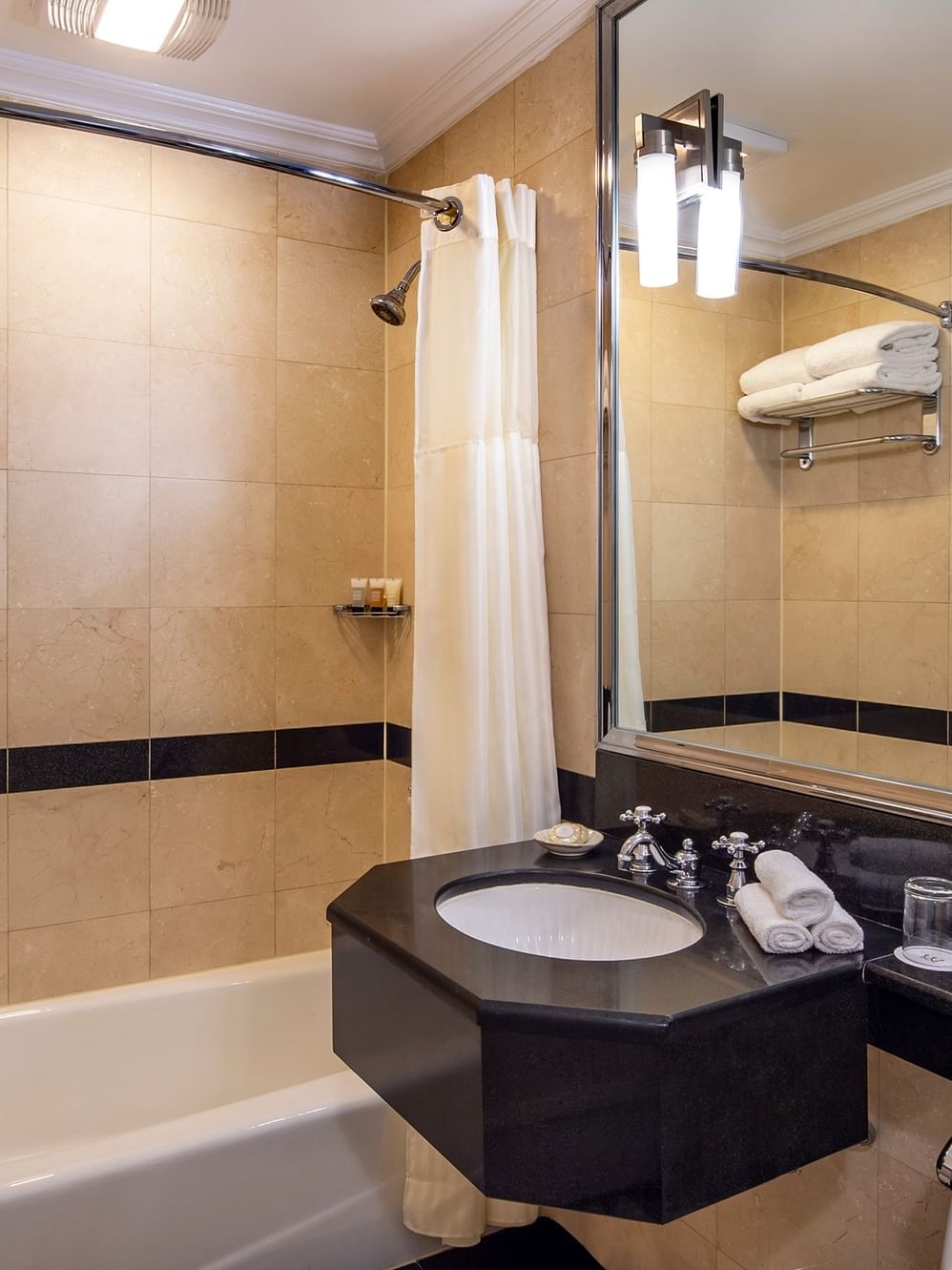 Premier Suite bathroom with marble vanity and glass shower at Warwick New York