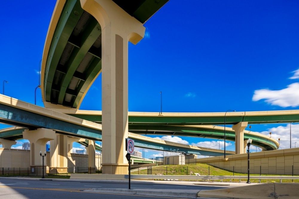 Intertwining overpasses of a Florida highway on a clear blue day.