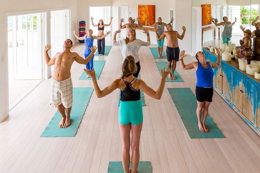 People doing yoga standing on mats at Retreat Costa Rica