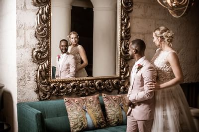 A wedding couple posing by a mirror at Bougainvillea Barbados