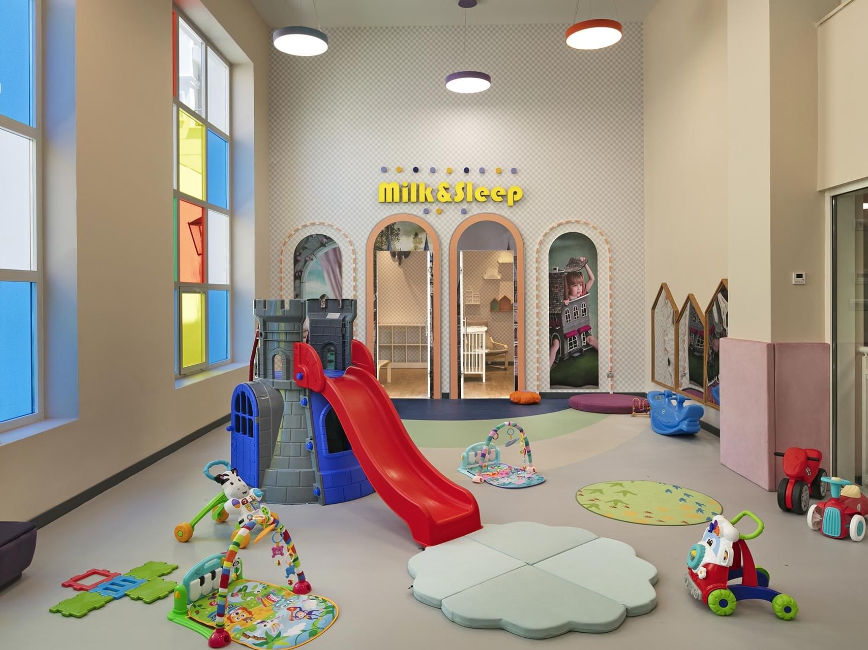 Indoor children's playroom with toys and a slide at Titanic Deluxe Golf Belek