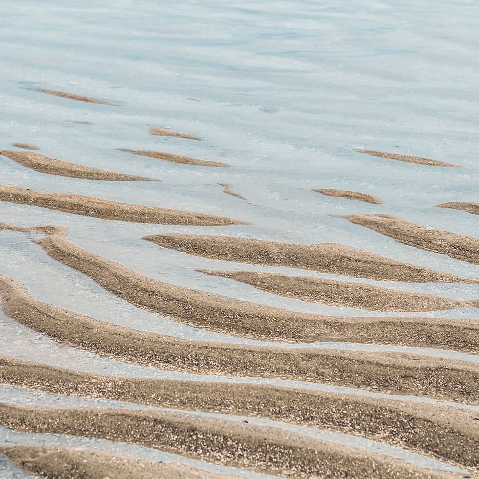 Close-up of sand piles over the water near Falkensteiner Hotels