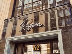 Close-up of the Riviera Restaurant sign on a stylish building facade near ReStays Ottawa