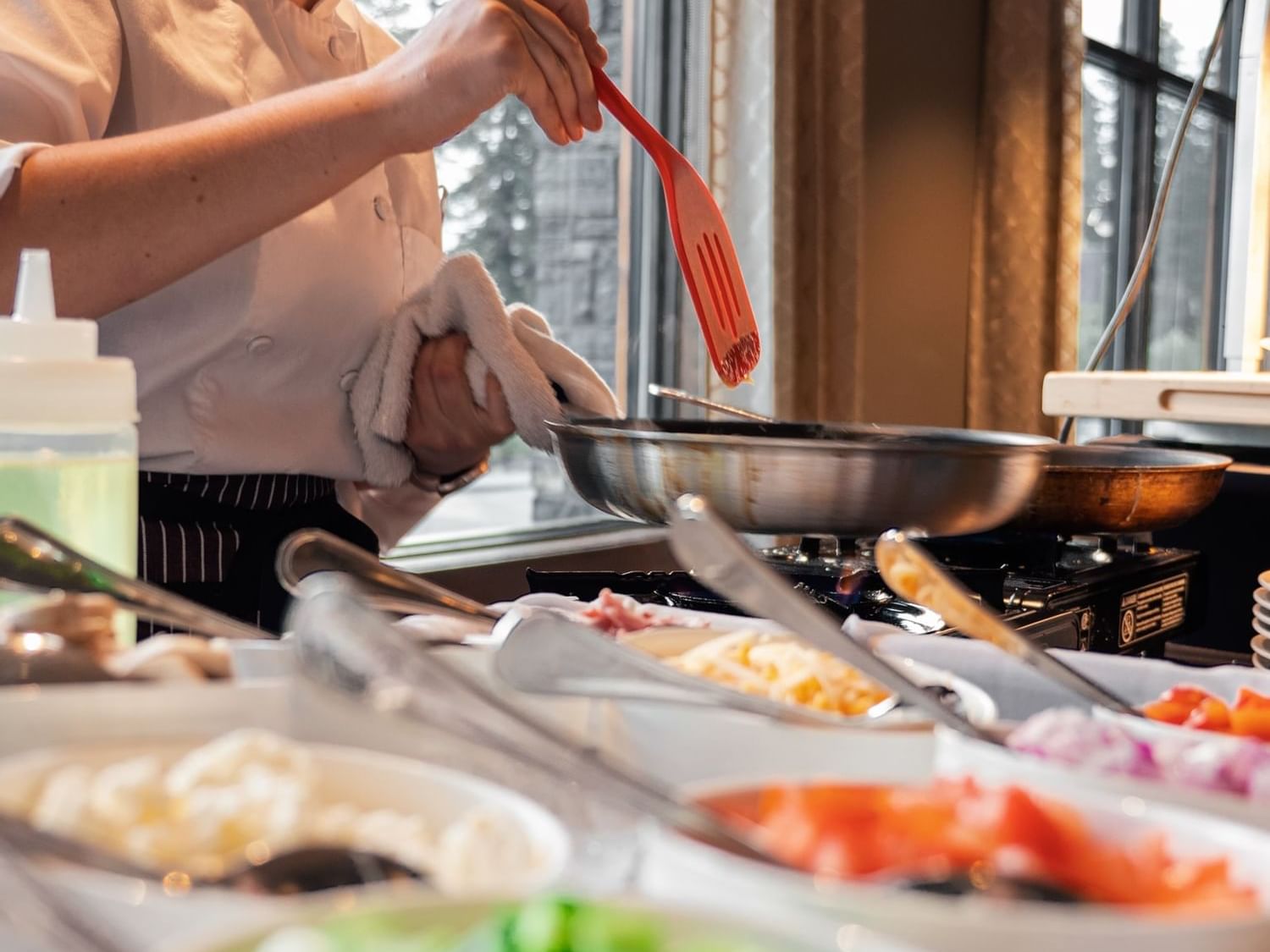 Chef preparing a fresh omelet at a live cooking station during Christmas Day Breakfast Buffet in Spring Creek Resorts