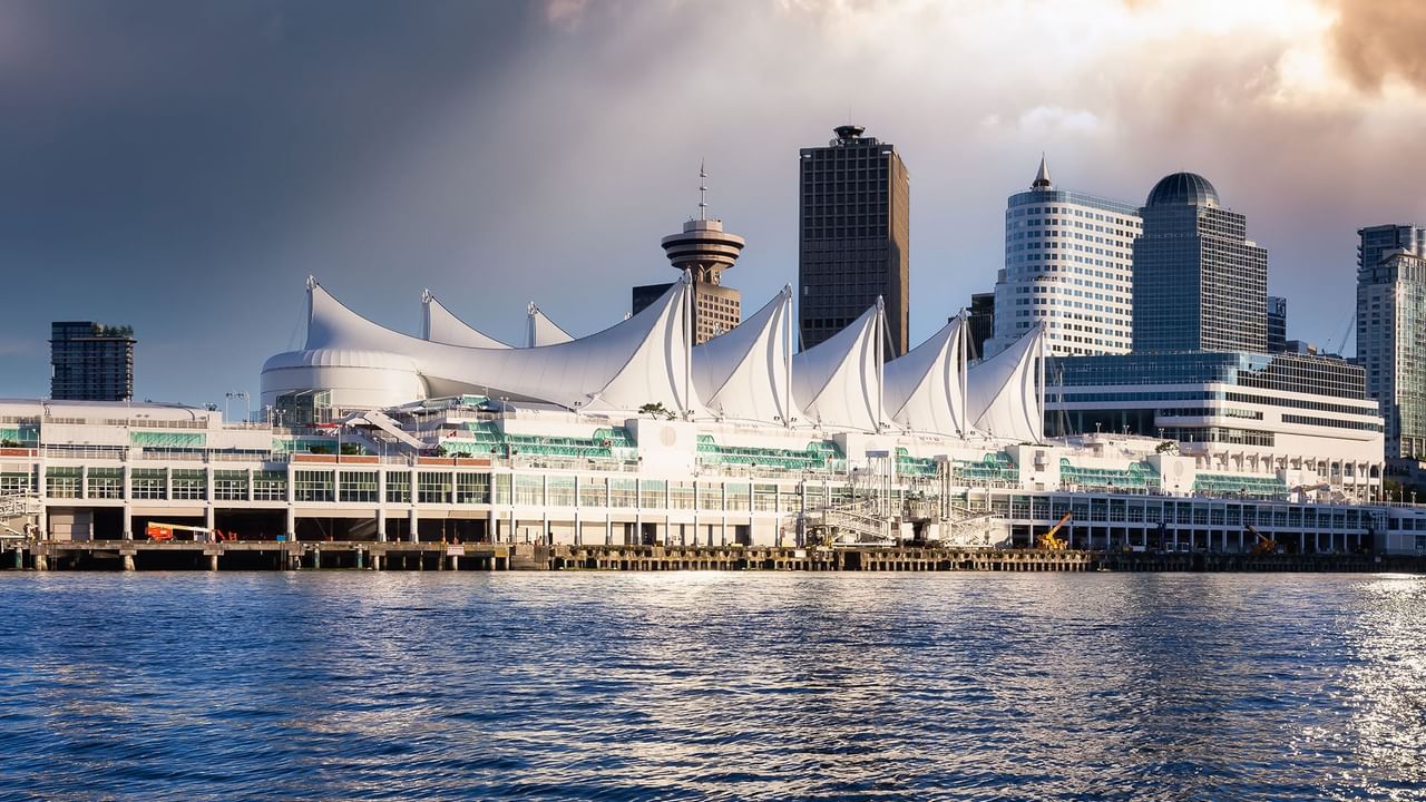 Vancouver waterfront with Canada Place's white sails, modern skyscrapers and pacific ocean.