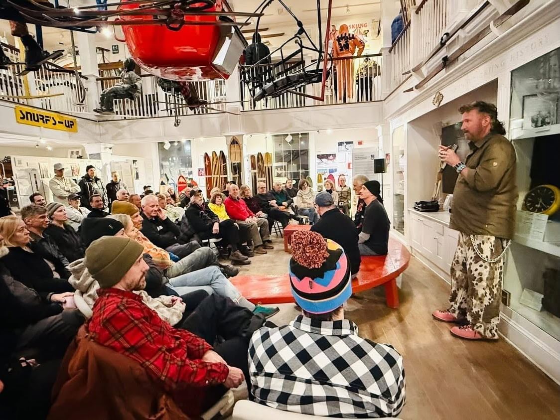Visitors gather for a presentation among vintage ski equipment and memorabilia at The Vermont Ski and Snowboard Museum