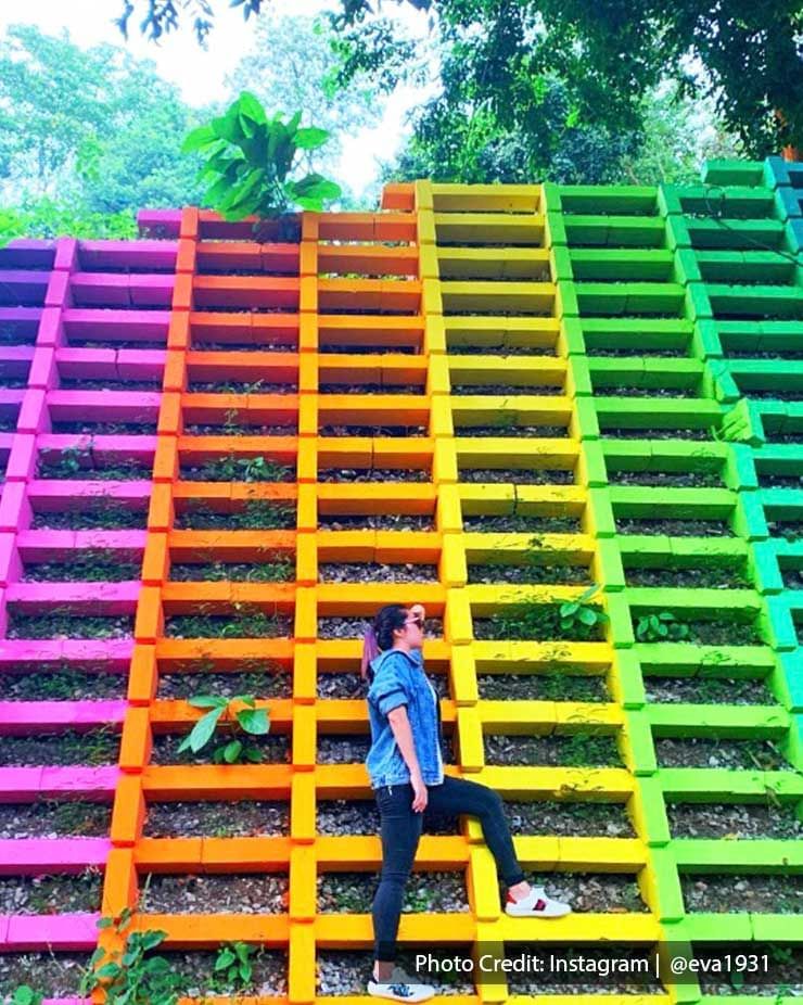 A lady was taking a picture with the rainbow wall at Pulau Jerejak - Lexis Suites Penang