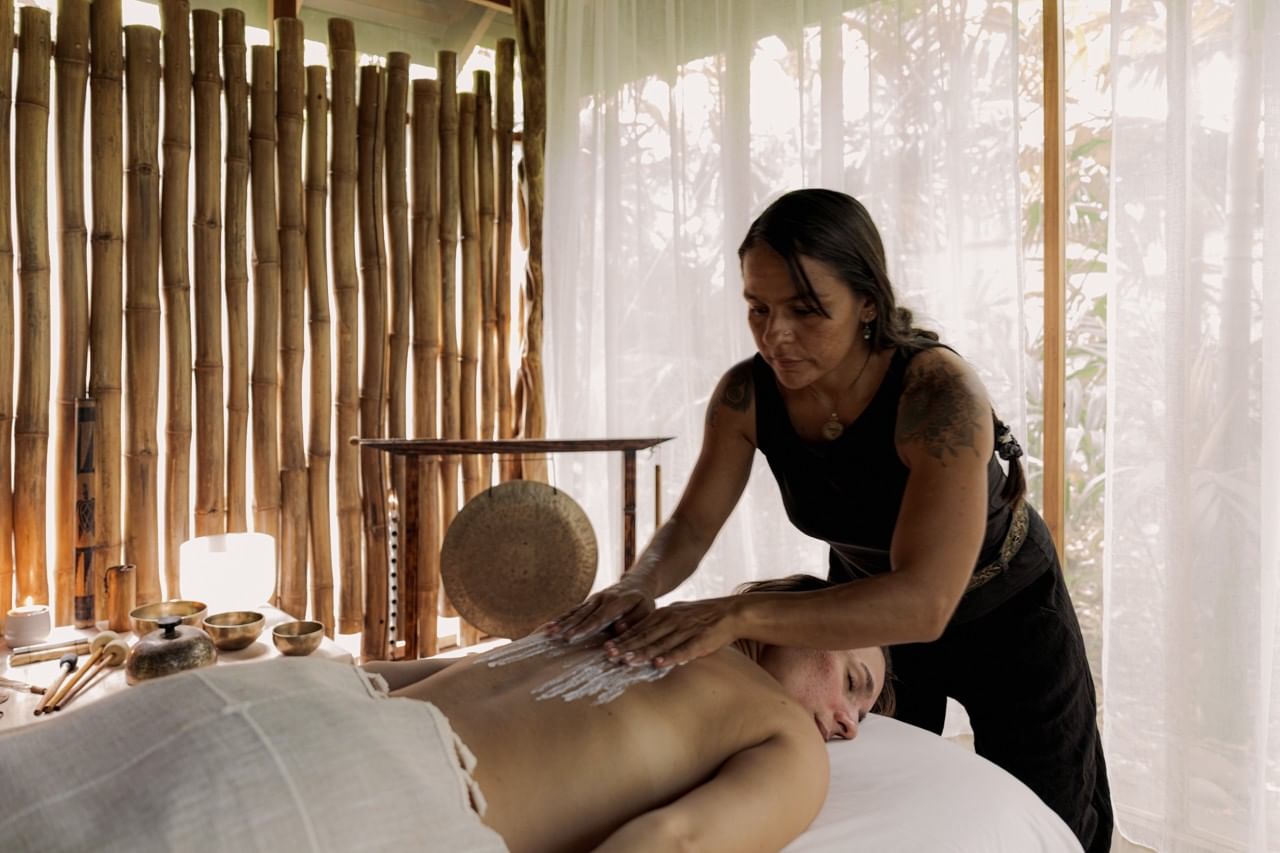Relaxing back massage done by a professional wellness therapist in Lahari Wellness Center at Cala Luna Boutique Hotel