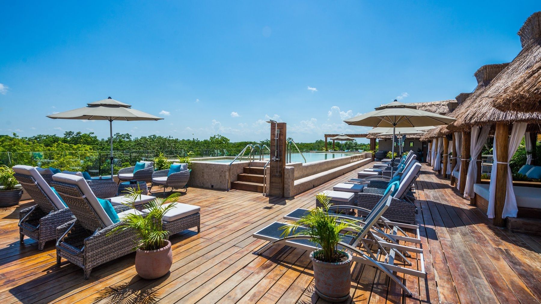 Lounge chairs by the pool of Naay Tulum Curamoria Collection