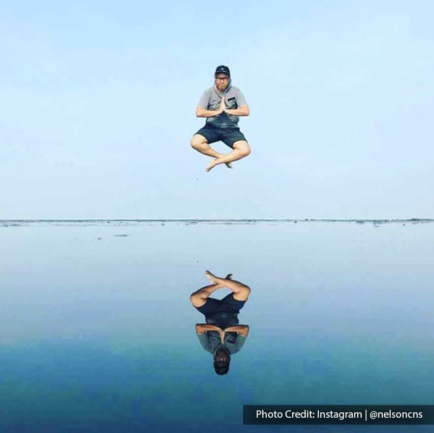 A man was striking a jump pose at Bagan Datuk Sky Mirror - Lexis Suites Penang