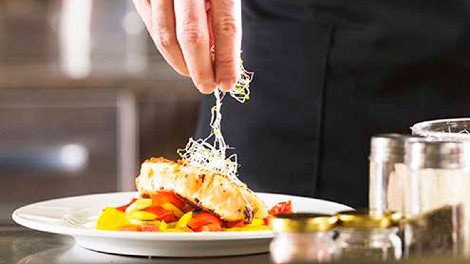 Chef garnishing a dish at The Signature Collection by Hideaway