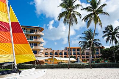 A sail boat docked with a hotel backdrop at Accra Hotels & Resorts