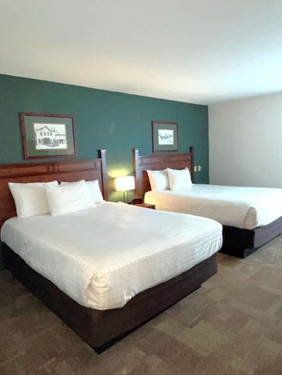 Two queen beds & nightstand in Double Queen at Boothill Inn & Suites