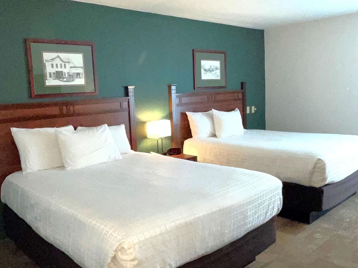 Two queen beds & nightstand in Double Queen at Boothill Inn & Suites