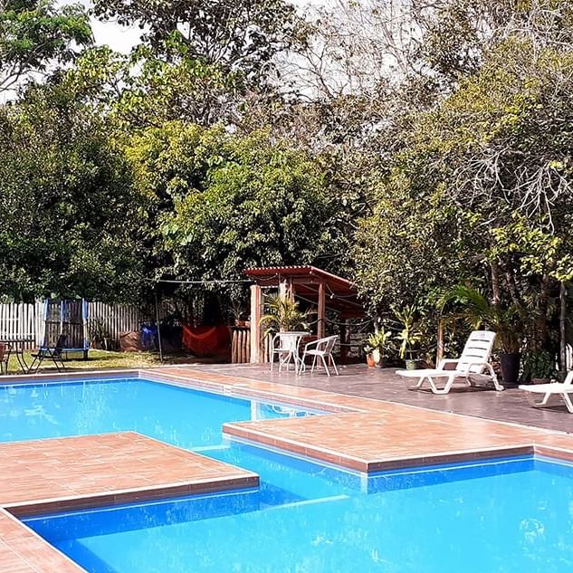 Pool with sun beds at Piscina Hotel Puerto Azul Sauce