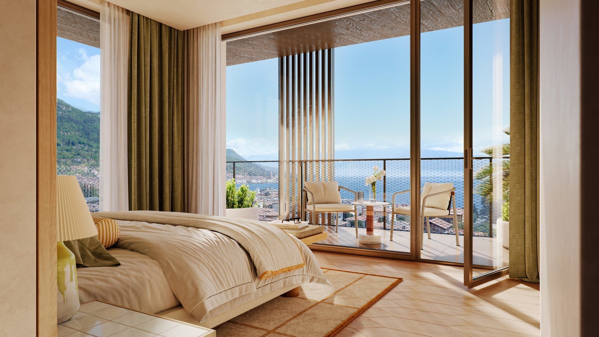 Bedroom with large bed and balcony overlooking the sea and mountains.