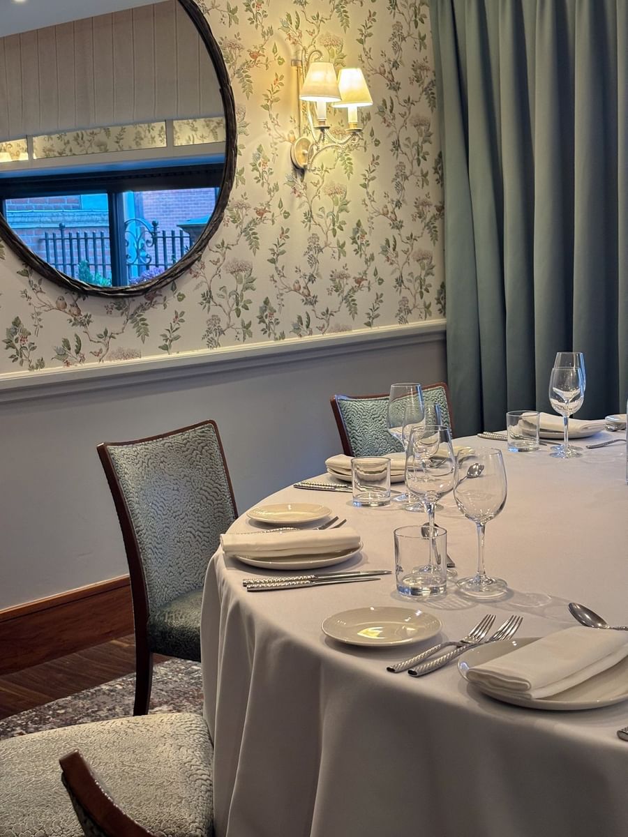 Dining table with hanging mirror in The Eaton at The Capital Hotel, Apartments and Townhouse
