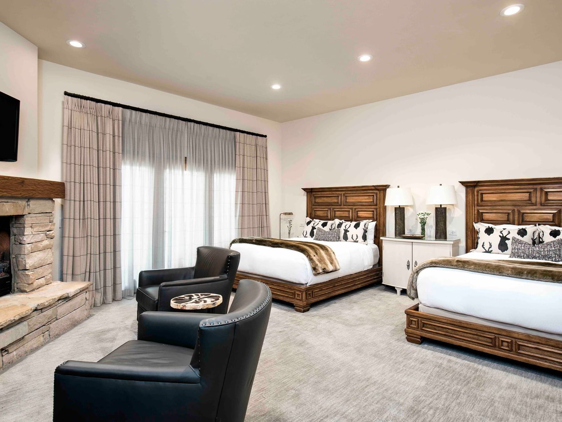 Deluxe room with 2 double beds & chairs at Stein Eriksen Lodge