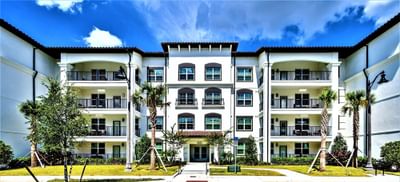Reserve exterior building with balconies and palm trees in front at Vista Cay Resort By Millenium