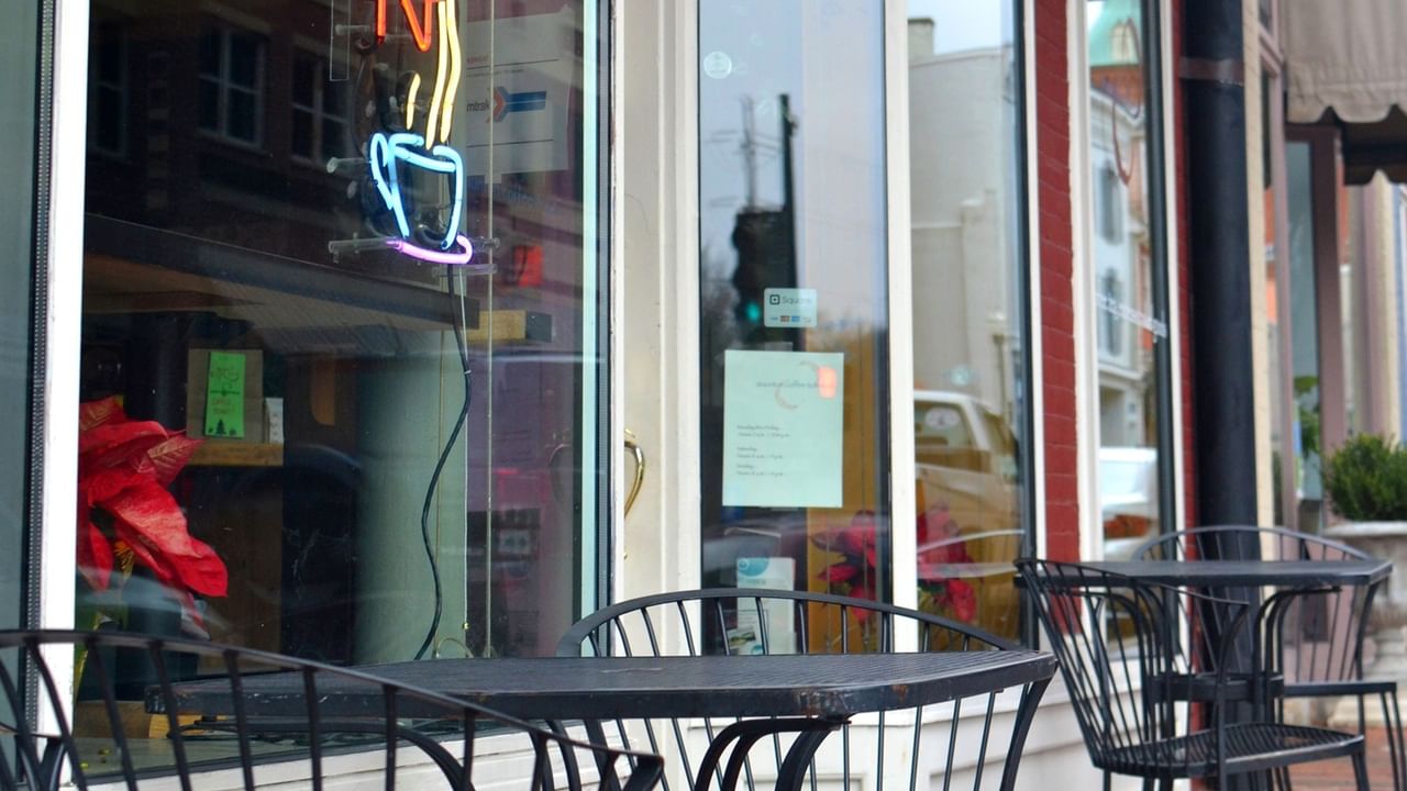tables and chairs in front of a cafe