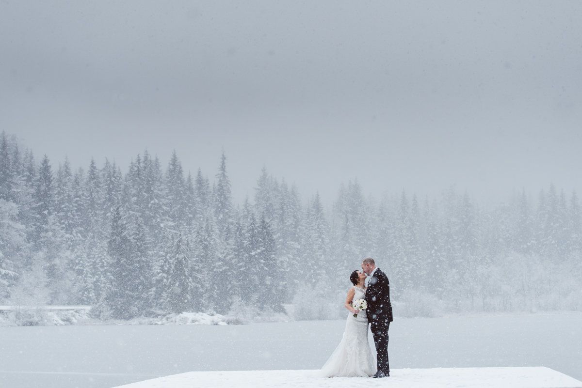 Wedded couple posing in the snow at Nita Lake Lodge