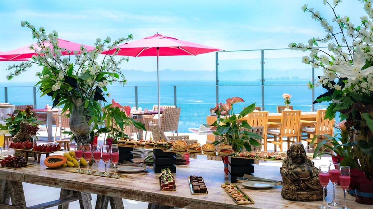 Seaside dining area with outdoor table set and ocean view in The Top Sky Bar at Almar Beach Resort
