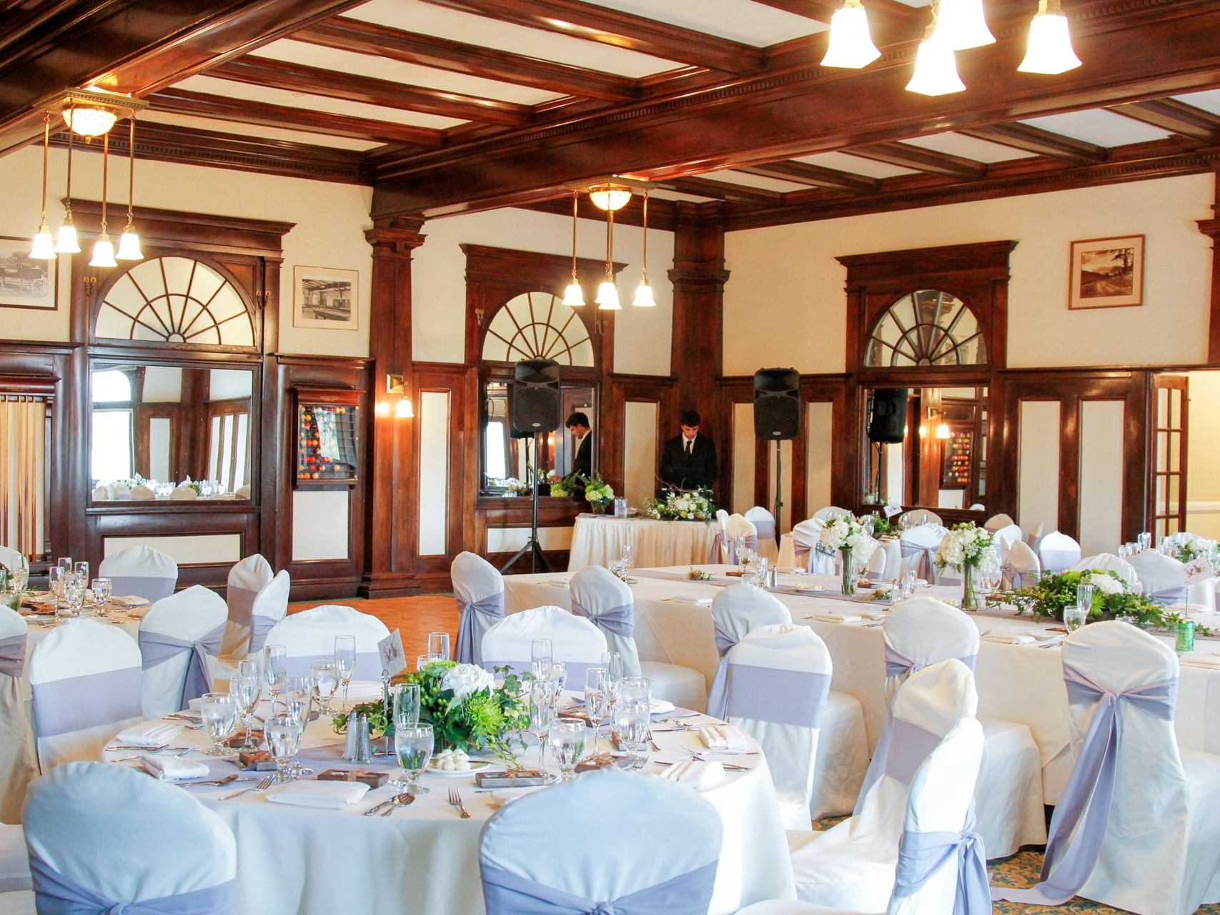 Pinion and Billard Ballroom - tables are set with flowers with a DJ in the background