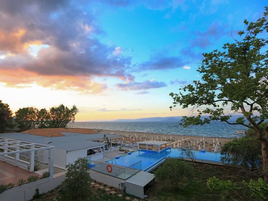 Exterior view of Cavomarina beach hotel at sunrise