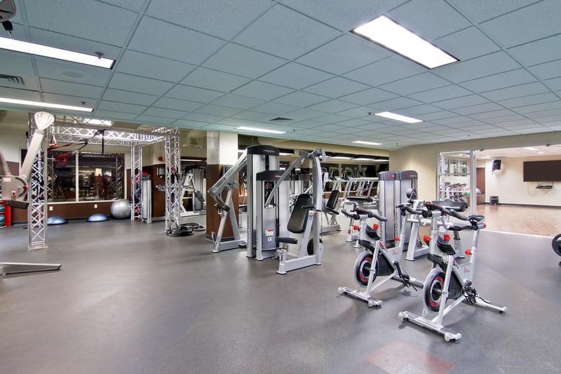 Grove Fitness Club with a variety of exercise machines and black flooring at Hotel 43 Boise