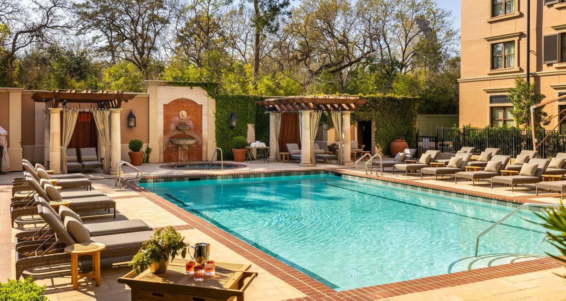 Serene pool area at Granduca Houston, one of the top Houston hotels with pools, featuring lounge chairs and cabanas