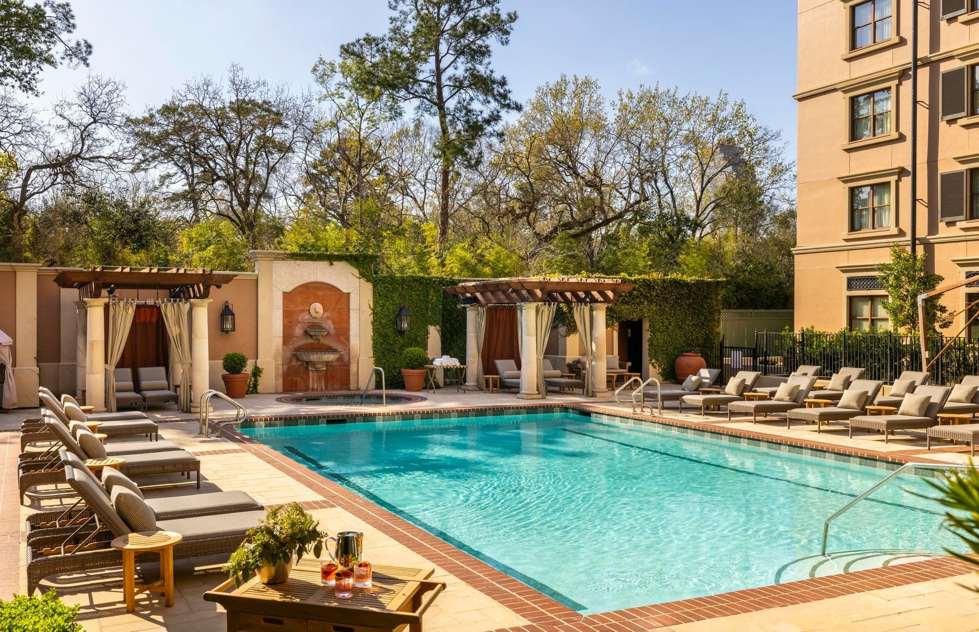 Serene pool area at Granduca Houston, one of the top Houston hotels with pools, featuring lounge chairs and cabanas