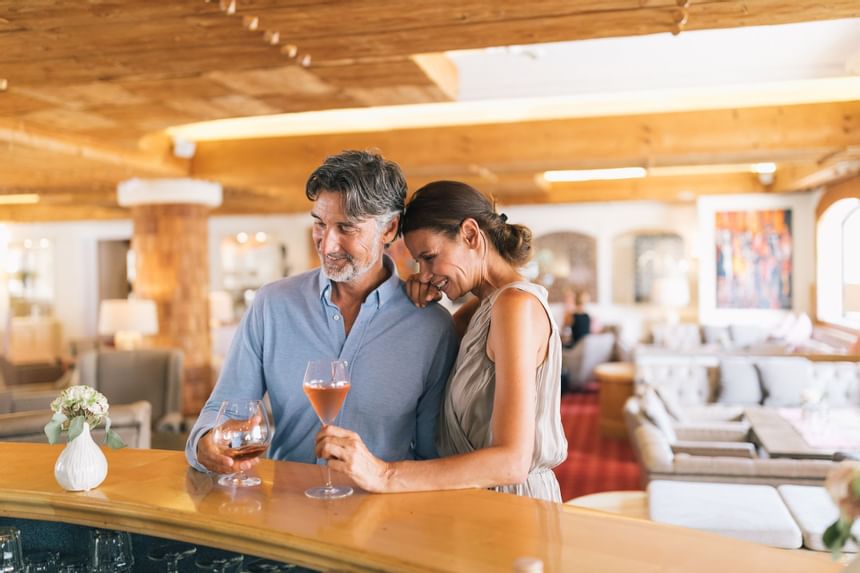 A man and a woman are enjoying their time in the lounge and bar 