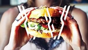 A lady eating a burger in Chur Burger at Novotel Sydney