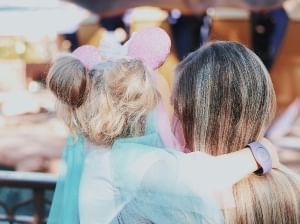 A young girl at Walt Disney World with her mother in 2024. 