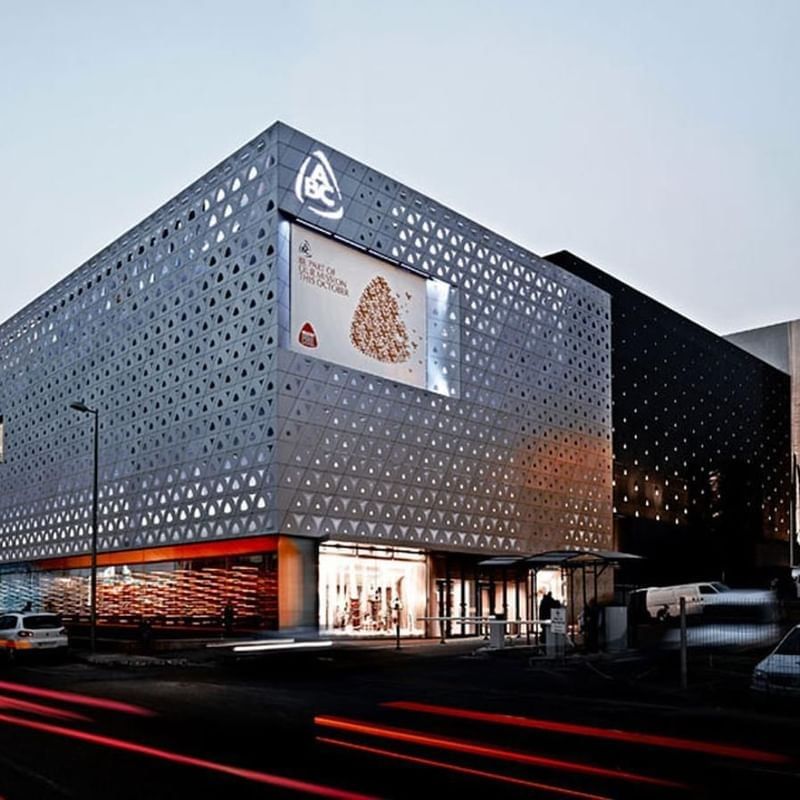 ABC Dbayeh Mall with a digital screen by a street at dusk near Warwick Stone 55 - Beirut