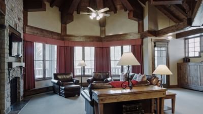 Loune area with plush seating and stand lamps by the window in Grand Luxury Suite at Hotel Park City Autograph Collection