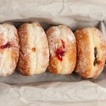 Close-up of jelly doughnuts in a box near Waikiki Resort Hotel by Sono