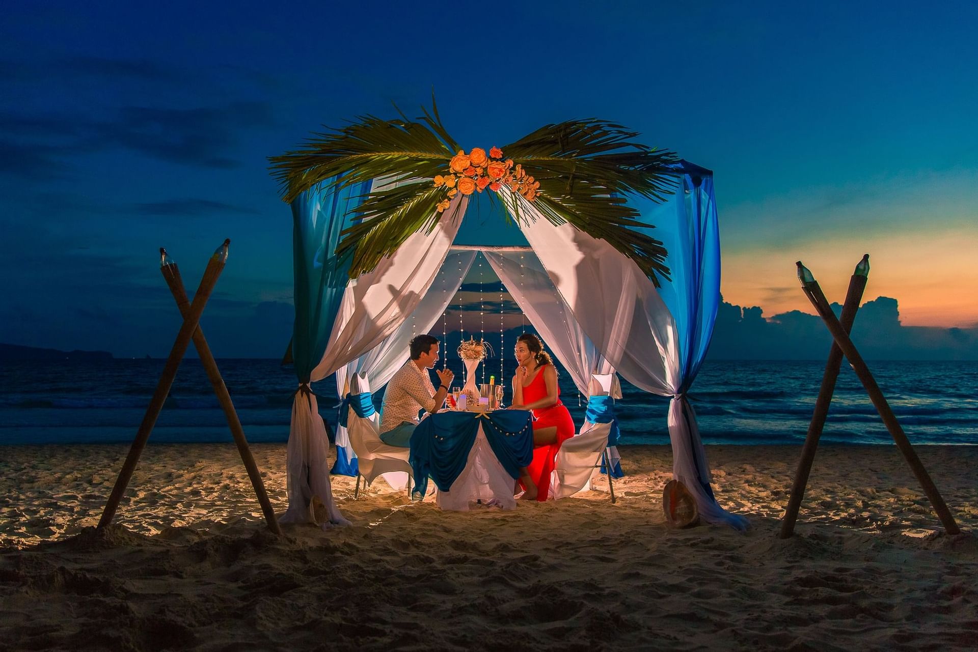 A couple romantic dining on a beach at Fiesta Resort