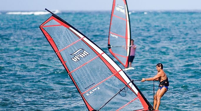 Tourists enjoying watersports near Serena Beach Resort & Spa