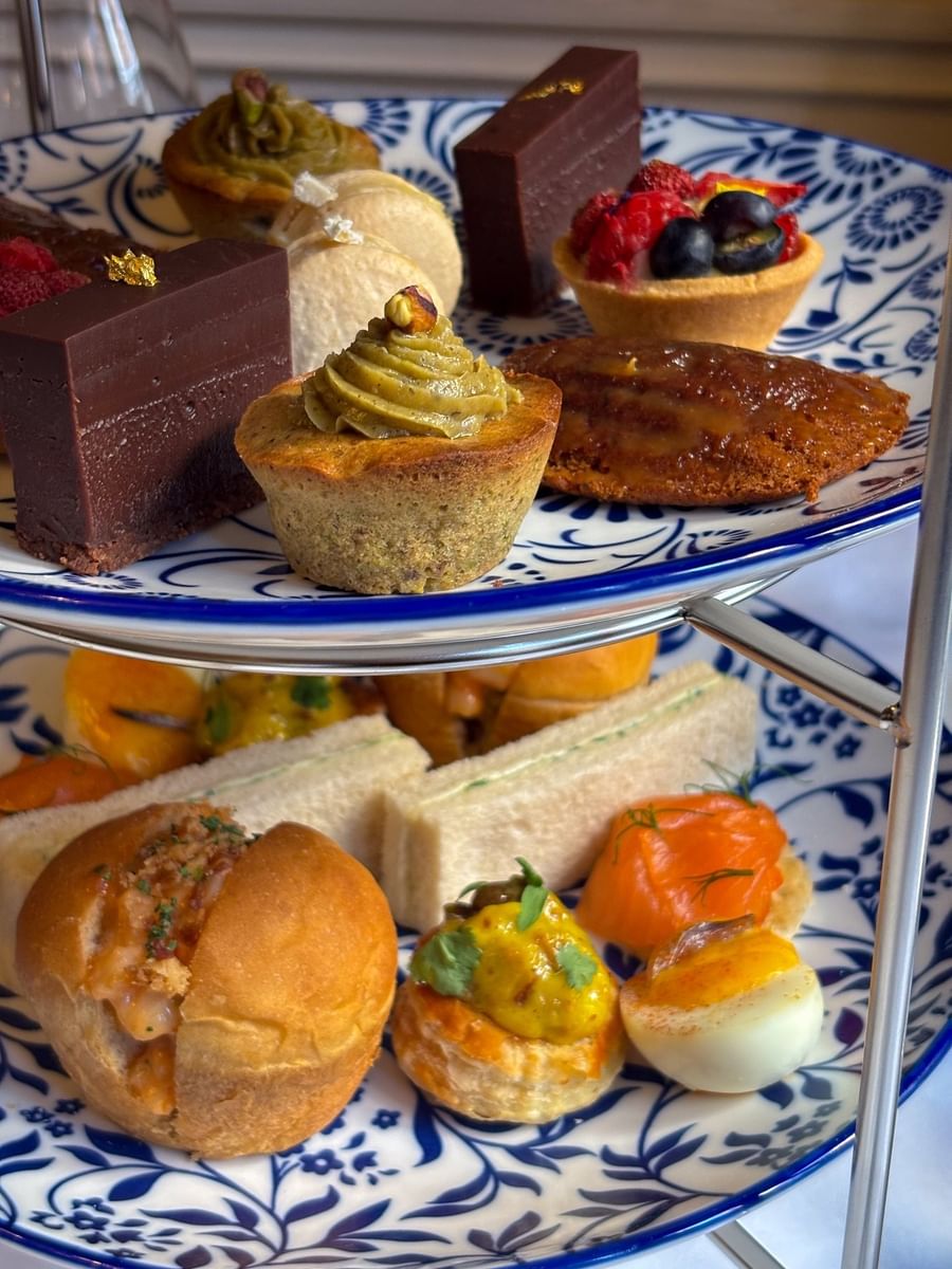 Assorted afternoon tea pastries and finger sandwiches at The Capital Hotel, Apartments and Townhouse