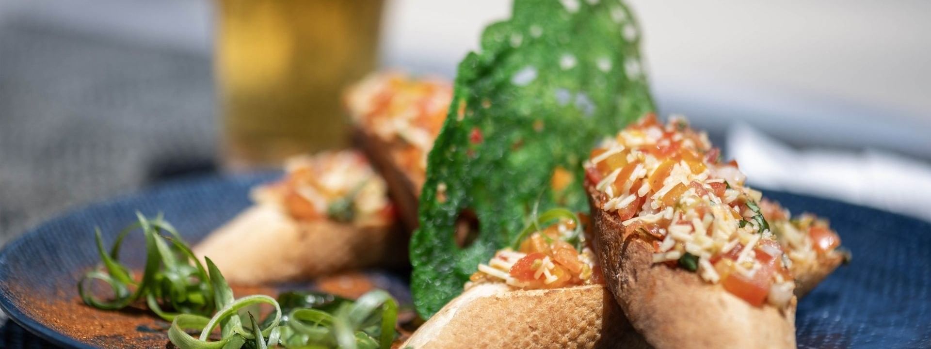 Delicious tomato bruschetta appetizers served on a blue plate in Pool Grill & Bar restaurant at warwick le lagon-vanuatu