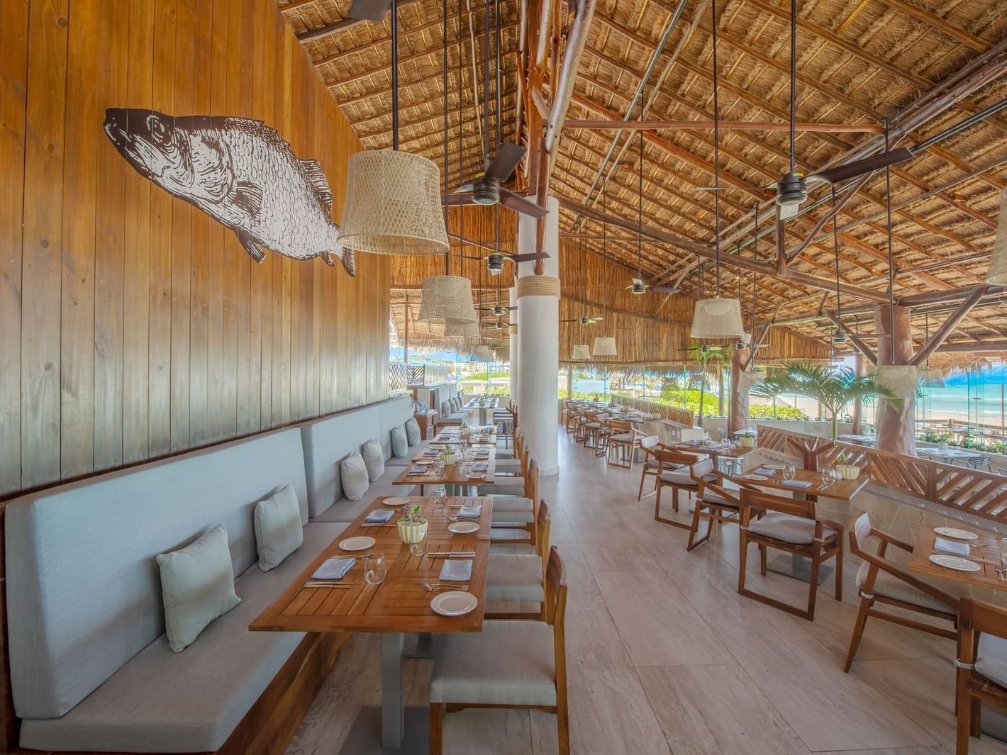 Azur restaurant with tables & booths at La Colección Resorts