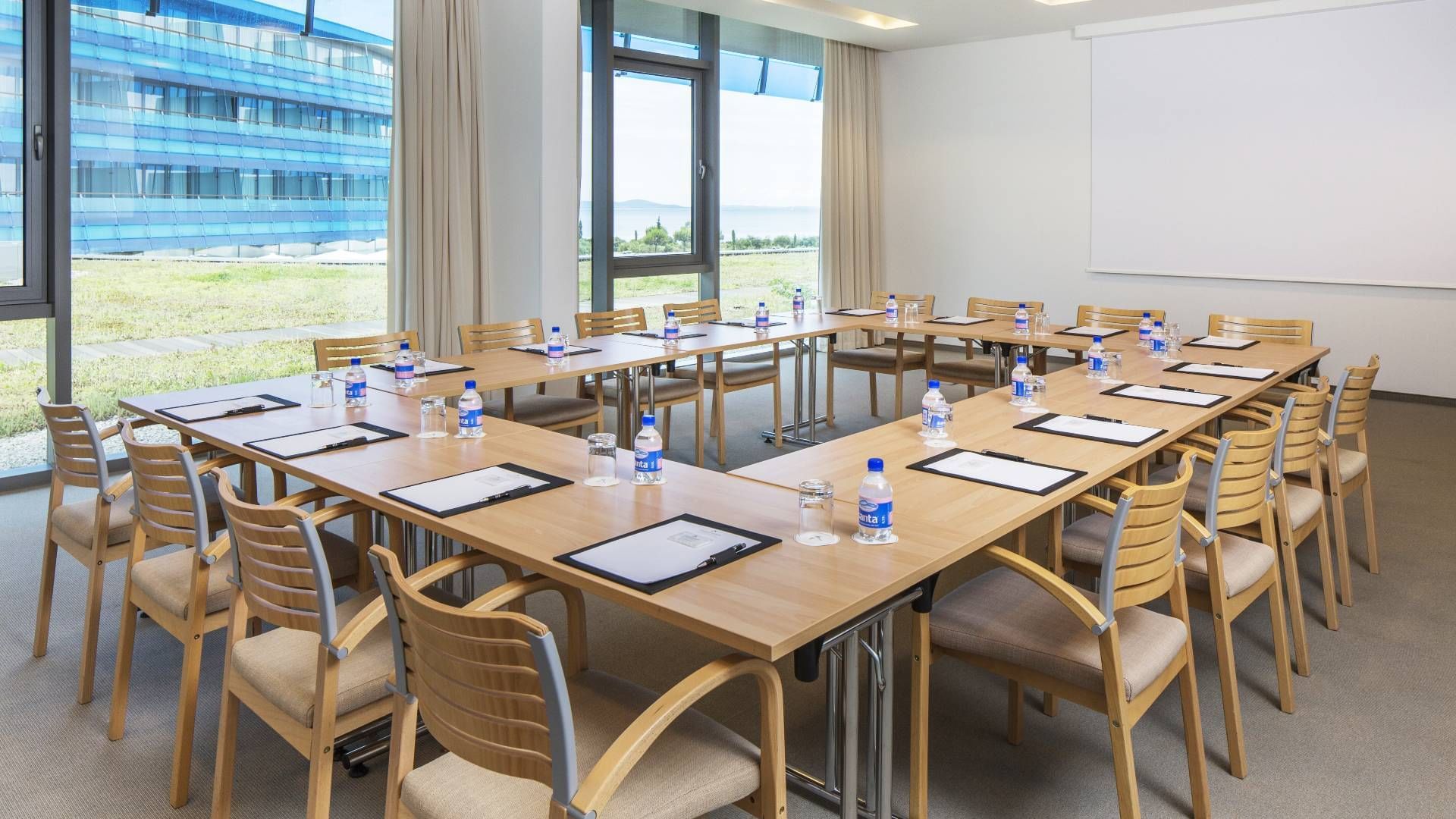 Wooden table arrangement in a meeting room at Falkensteiner Punta Skala