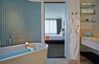 a large tub and robe in a bathroom