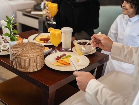 Family enjoying room service meal at Saja by Warwick Madinah.