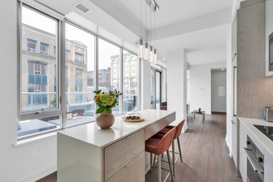 Kitchenette with dining area and large window in One-Bedroom Penthouse at ReStays Ottawa