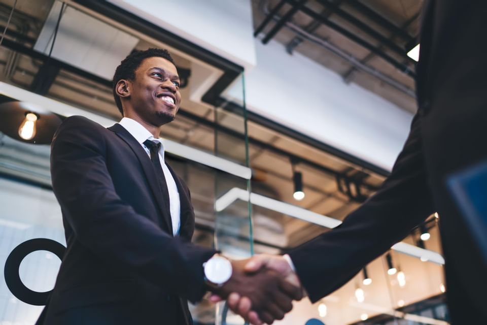 Two businessmen shaking their hands at Sunseeker Resort