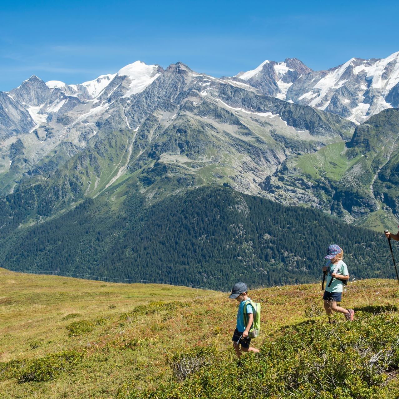 Three hikers on a mountain while hiking near Originals Hotels