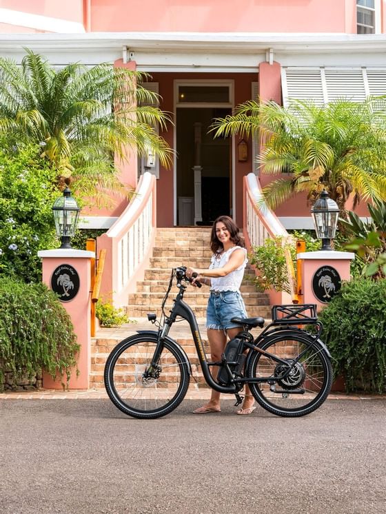 Woman happily posing with her electric bike at Royal Palms Hotel