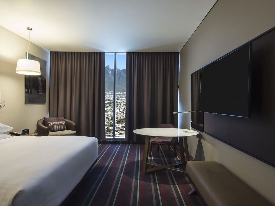 King bed, TV & Desk in Deluxe Room at FA Monterrey Pabellon M